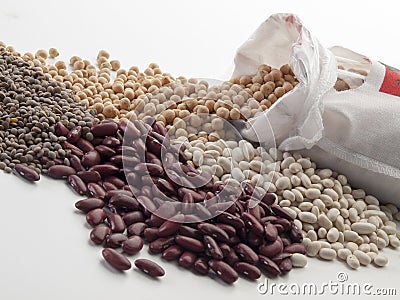 A sack of cloth emptying chickpeas mixed with lentils, red and white beans Stock Photo