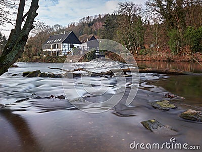 Half-timbered houses on the river bank. View on the Wipperkotten on the Wupper river. Stock Photo