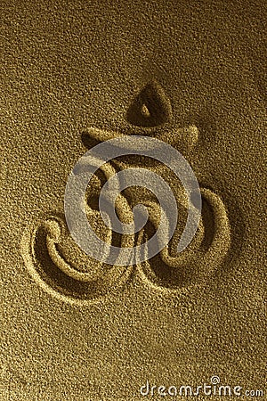 Om symbol hand drawn in the sand Stock Photo