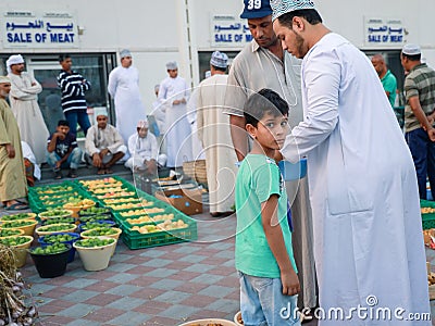 Omani kid buying fresh fruits in fruit bid market Editorial Stock Photo