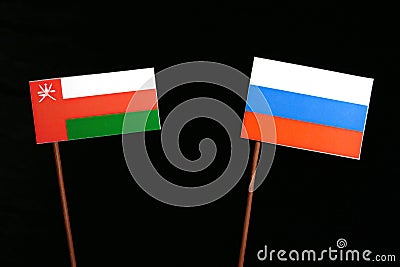 Omani flag with Russian flag on black Stock Photo