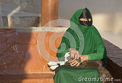 Omani woman in a market with a baby goat Editorial Stock Photo