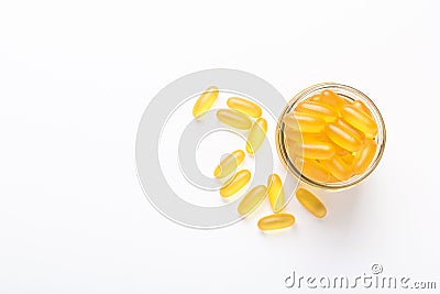 Omega 3 capsules in glass jar on white background Fish oil Yellow softgels Vitamin D, E, A supplement Stock Photo