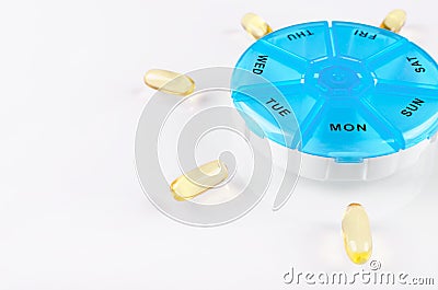 Omega capsules with a pills box on white background Stock Photo