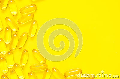 Omega 3 fish oil capsules on yellow background. Concept of healthcare. Stock Photo