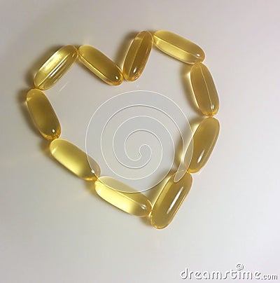 Omega pills in shape of heart Stock Photo