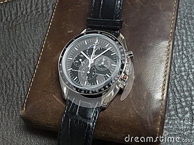 Omega Speedmaster with wallet Editorial Stock Photo