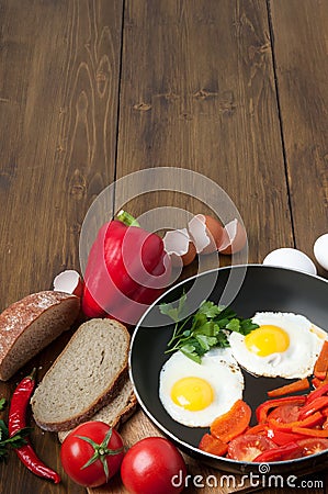 Omelet with bread, tomatoes and bell pepper in skillet pan. Stock Photo