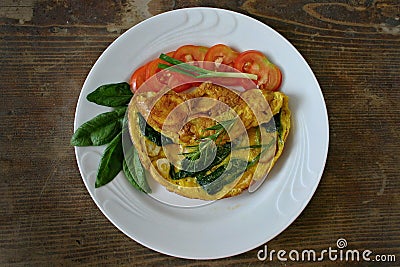 Omelet with eggs, potatoes and spinach Stock Photo