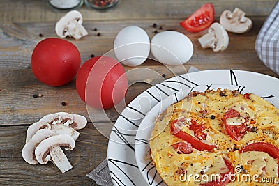 Omelet with onion, tomatoes and mushrooms Stock Photo