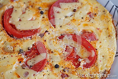 Omelet with onion, tomatoes and mushrooms Stock Photo