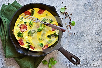 Omelet with vegetables in a cast-iron pan Stock Photo