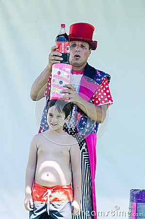 Omer (Beer-Sheva), ISRAEL -Clown with a boy shows focus with a bottle of Pepsi-Cola, July 25, 2015 in Israel Editorial Stock Photo