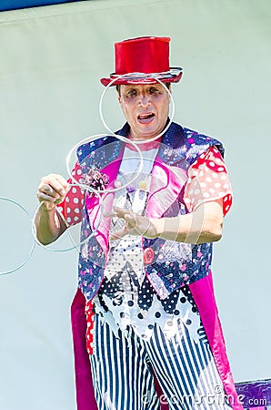 Omer (Beer-Sheva), ISRAEL -The clown in a red hat stands with four metal rings, July 25, 2015 in Israel Editorial Stock Photo