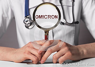 Omicron word, corona virus strain. Text through magnifying lens Stock Photo
