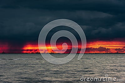 Ominous fiery dawn on the sea Stock Photo