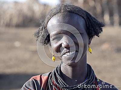 OMO RIVER, ETHIOPIA, MAY 11TH. 2019, Portrait of girl of Dassanech tribe, May 11Th. 2018 dating in Omo river, Ethiopia Editorial Stock Photo