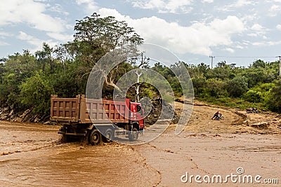 OMO VALLEY, ETHIOPIA - FEBRUARY 4, 2020: Truck crossing Kizo river, Ethiop Editorial Stock Photo