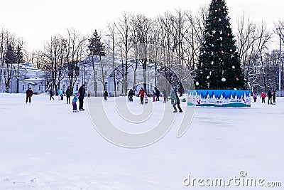 Omsk, russia, 2 January 2022.Winter ice rink. The people in the skate riding on the ice. Active family sport during the Editorial Stock Photo