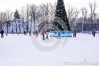 Omsk, russia, 2 January 2022.Winter ice rink. The people in the skate riding on the ice. Active family sport during the Editorial Stock Photo