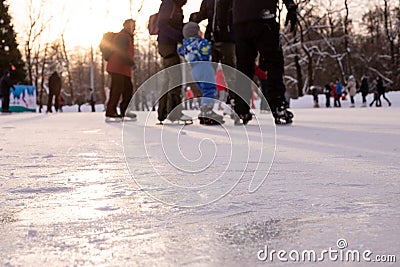 Omsk, russia, 2 January 2022.Winter ice rink. The people in the skate riding on the ice. Active family sport during the Editorial Stock Photo