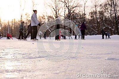 Omsk, russia, 2 January 2022.Winter ice rink. The people in the skate riding on the ice. Active family sport during the Editorial Stock Photo