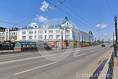 Omsk, Russia. Modern street in the background of a building built in the 19th century Editorial Stock Photo