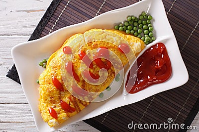 Omurice omelet stuffed with rice closeup. Horizontal top view Stock Photo