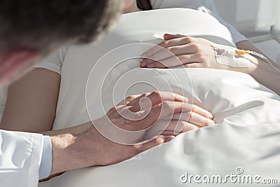 Oncologist holding hand of girl Stock Photo