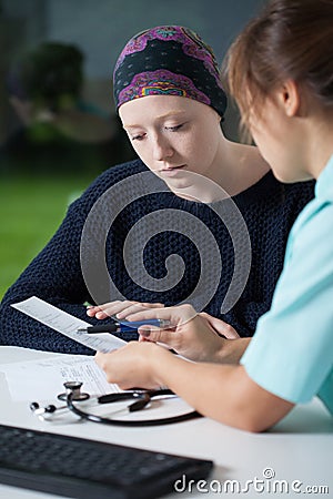 Oncologist talking with young woman Stock Photo