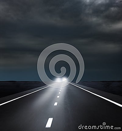 Oncoming headLights on Dark Road Stock Photo