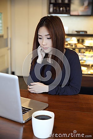 One Asian woman thinking with smart phone Stock Photo