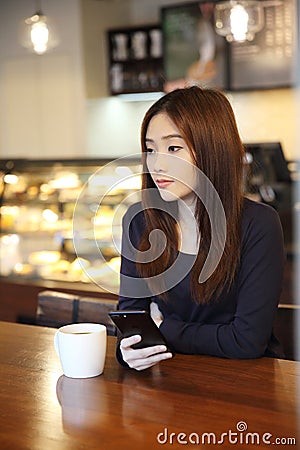 One Asian woman thinking with smart phone Stock Photo