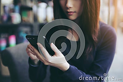 One Asian woman thinking with smart phone Stock Photo