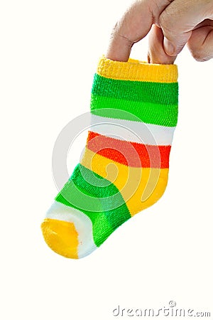 One baby sock in woman's hand. Stock Photo