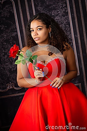 Beautiful, Biracial High School Senior wearing red prom dress Stock Photo