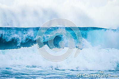 One beautiful and blue wave broking - sea or ocean beach - surfing time lifestyle - close up and portrait of a wave Stock Photo