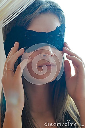 One beautiful glamour young woman with black band of lace on the face blindfold Stock Photo