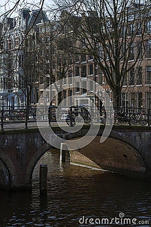 One beautiful old dutch bridge in the sunny day in autumn in the center of Amsterdam Editorial Stock Photo
