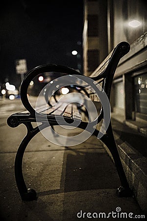 One bench at night with reflection of light Stock Photo