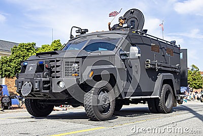 One big black Army vehicle driving through the Fourth of July Parade Editorial Stock Photo