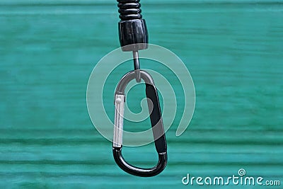 One black metal carabiner clasp on a plastic wire Stock Photo