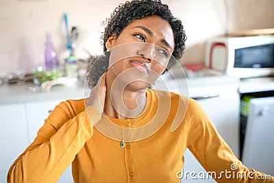 One black woman working at home suffering neck pain Stock Photo