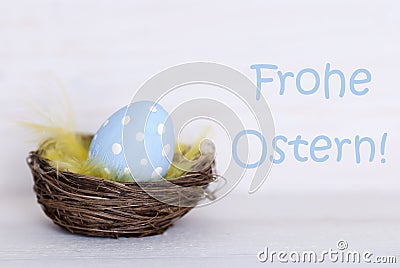 One Blue Easter Egg In Nest With German Frohe Ostern Means Happy Easter Stock Photo