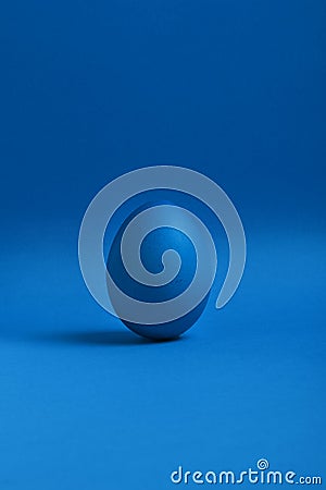 Blue egg on blue background Stock Photo