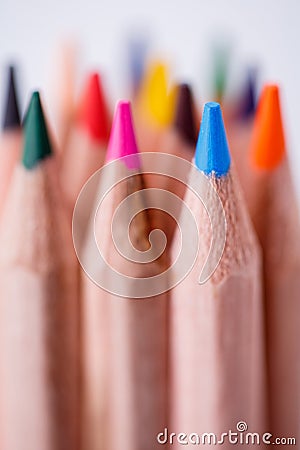 One blue pencil standing out from the other pencils. Leadership, uniqueness, independence, initiative, Stock Photo
