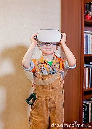 One boy is experiencing virtual reality, a children`s role-playing profession is a builder Stock Photo