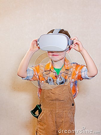 One boy is experiencing virtual reality, a children`s role-playing profession is a builder Stock Photo