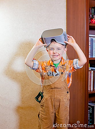 One boy is experiencing virtual reality, a children`s role-playing profession is a builder Stock Photo