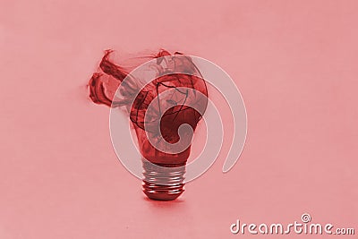 One broken light bulb on a blue background with smoke. Overdue idea concept Stock Photo